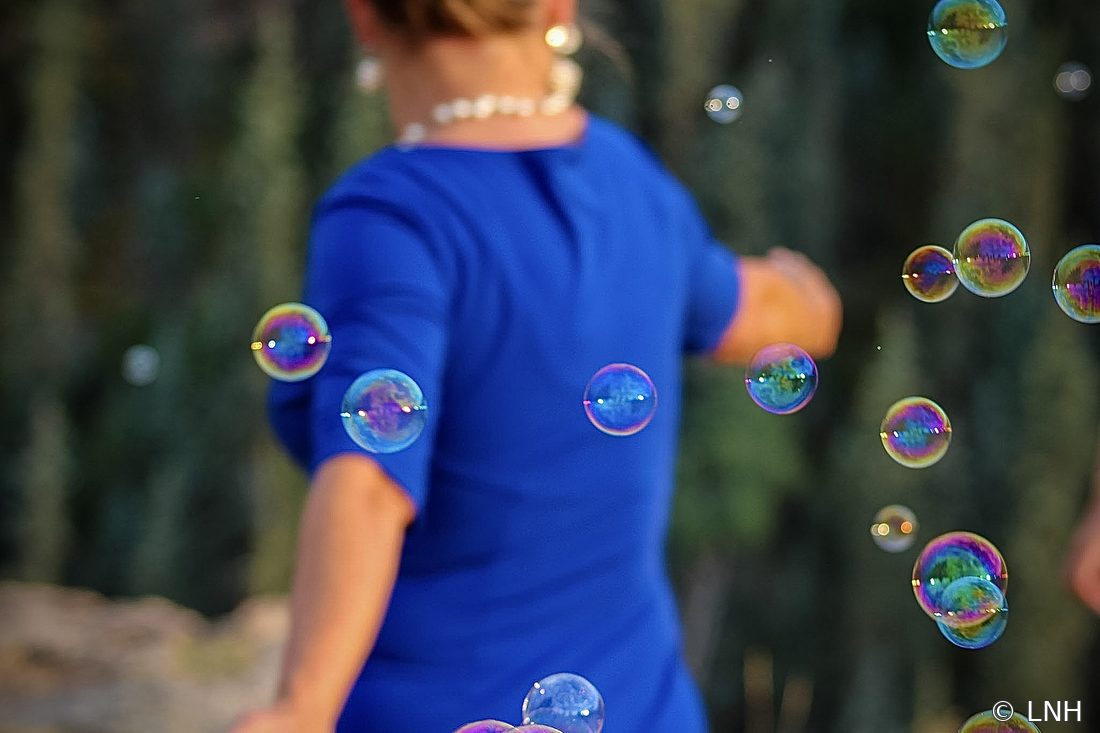 Bubbles floating around a guest in blue