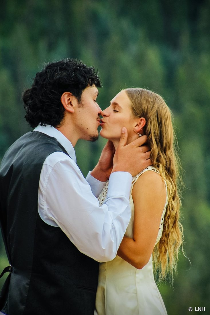 A couple kissing in the mountains