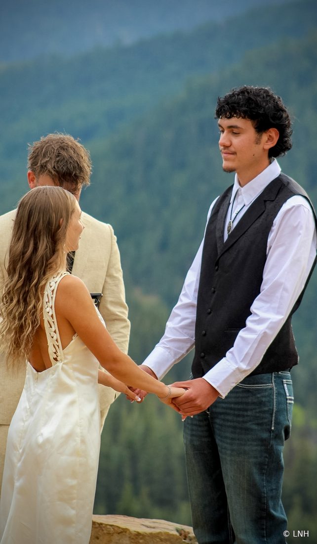 A couple holding hands during their ceremony
