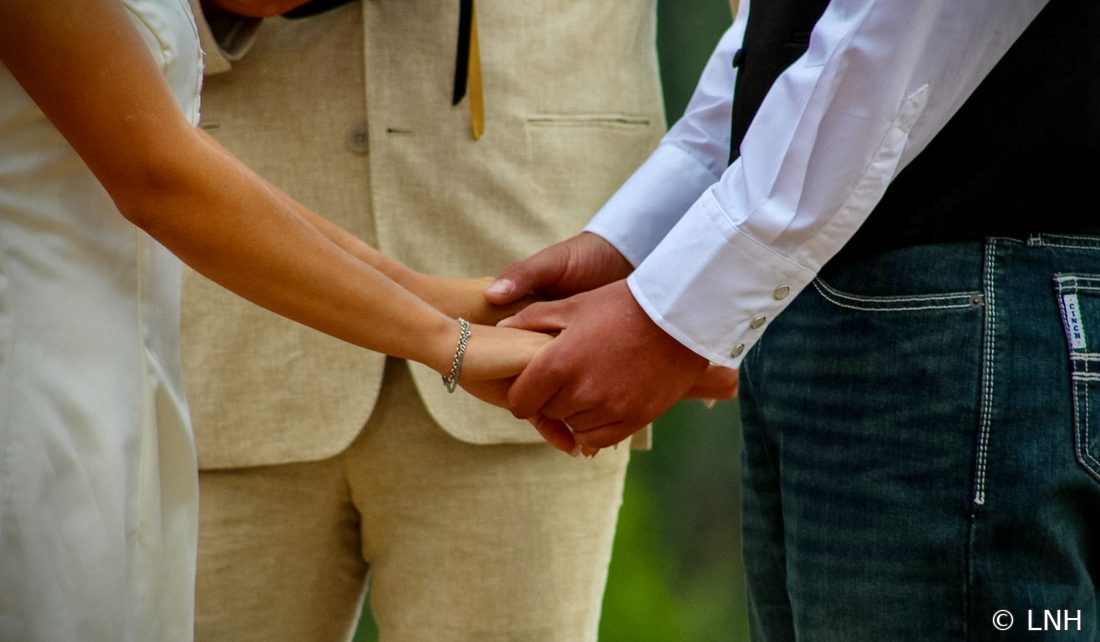 A close-up of hands held during the ceremony